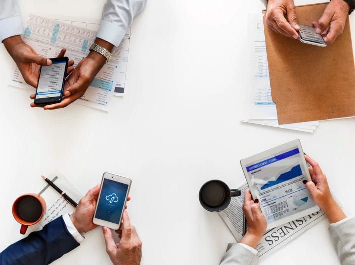 people reading news on devices